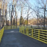 Curving ramp that has yellow railings
