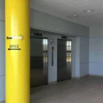 Elevators with with beam that has Beehive Storage logo